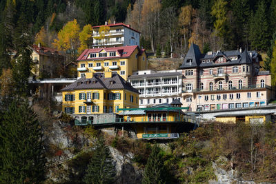 High angle view of houses amidst trees and buildings