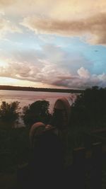 Scenic view of lake against cloudy sky