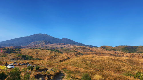 Scenic view of mountains against clear blue sky