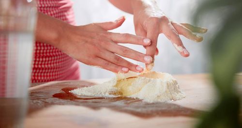 A woman is cooking with plain flour and eggs