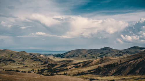 Scenic view of arid landscape against sky