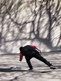 Man about to pick up ball