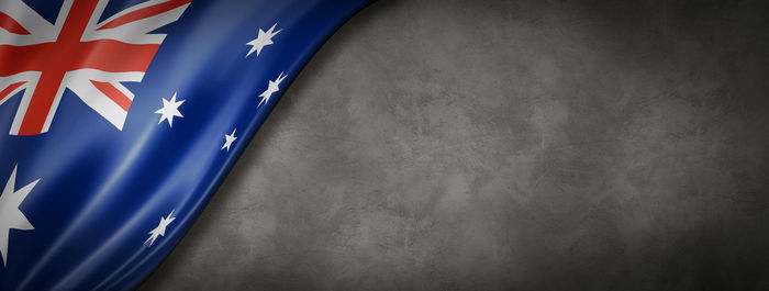 Close-up of flag against blue wall