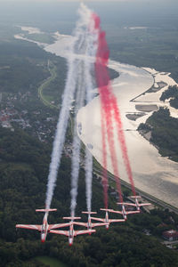 High angle view of airplane flying over river against sky