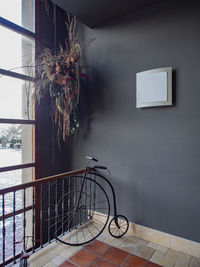 Bicycle by railing against wall at home