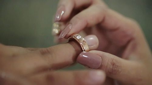 Close-up of couple holding hands