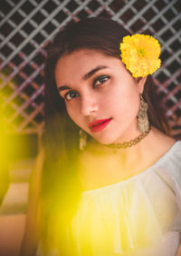 Portrait of young woman wearing flower in hair