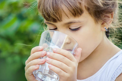 Close-up of young woman drinking water