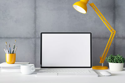 Yellow electric lamp on table