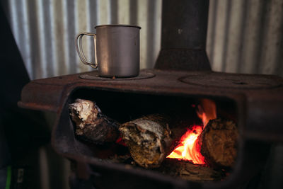 Close-up of burning candles on barbecue grill