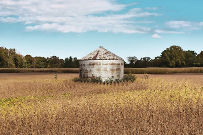 Barn on field against sky