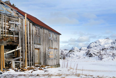 Snow covered houses against sky