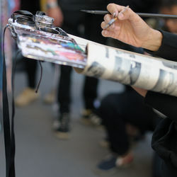 Cropped hands of artist painting outdoors