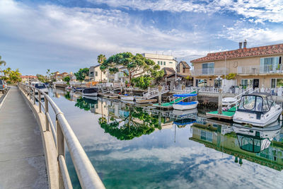View of swimming pool by buildings against sky