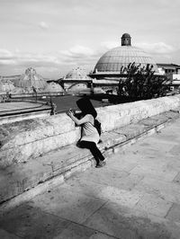 Full length of young woman jumping