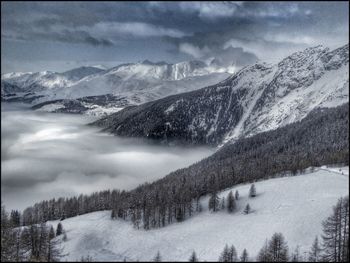 Scenic view of snow covered mountains against sky