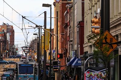 Tram and cars on street in city