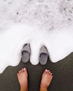 Low section of woman standing on beach