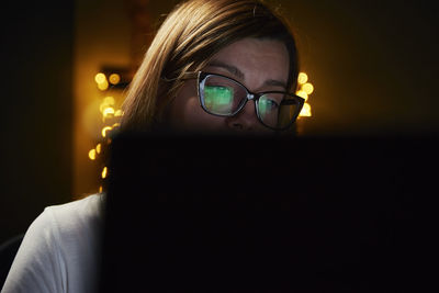 Tired woman works late at home workplace