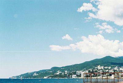 Calm sea against mountain range