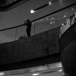 Low angle view of woman standing on illuminated wall