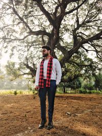 Full length of man standing by tree