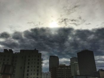 View of skyscrapers against cloudy sky