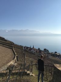 Man looking at sea against clear sky