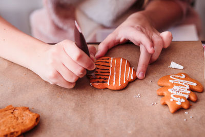 Close-up of woman decorating cookies