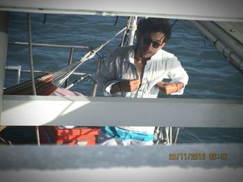 Man working on boat in sea