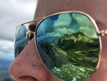 Reflection of sunglasses on sea against sky