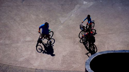 High angle view of friends with bicycles on street