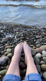 Low section of person on rock at beach