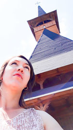 Low angle portrait of young woman looking away