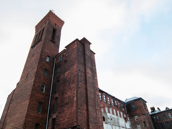 Low angle view of clock tower against sky