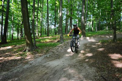 Man riding bicycle in forest