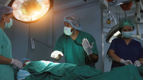 Rear view of doctor examining patient at clinic