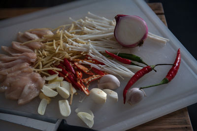 High angle view of chopped vegetables in plate on table