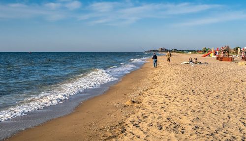 People on beach against sky