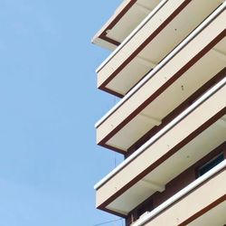 Low angle view of modern building against blue sky