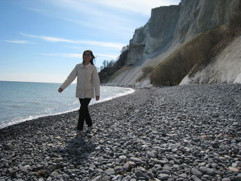 Full length of woman walking at beach