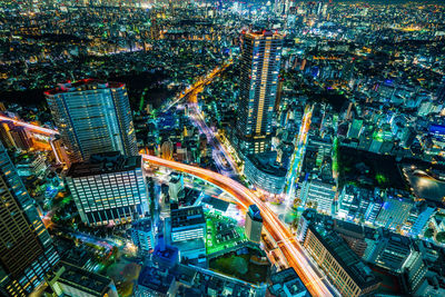 High angle view of illuminated buildings in city at night