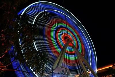 Illuminated ferris wheel at night