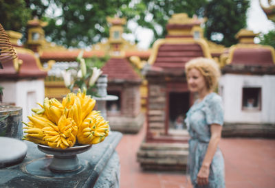 Woman with yellow flowers at temple