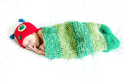 High angle view of baby boy sleeping on bed
