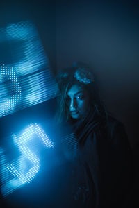 Portrait of young woman in darkroom