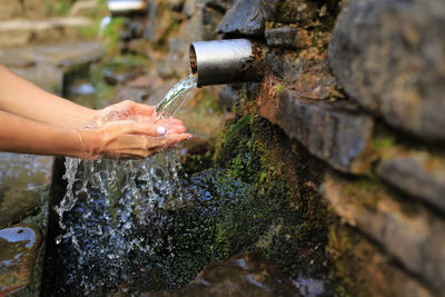 Cropped hand of person washing hands