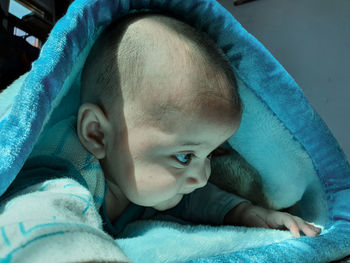 Portrait of cute baby lying down on bed