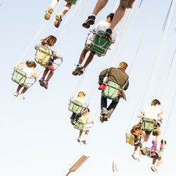 Low angle view of people in amusement park