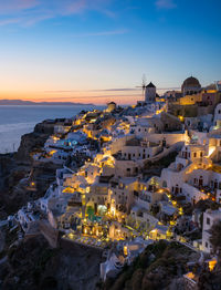 High angle view of townscape by sea against sky